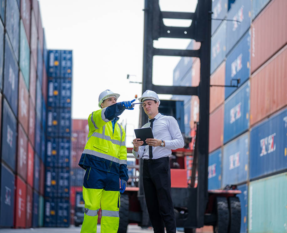 Manager and Technicians planning the transportation of goods for import Or export in the container yard,Checking on shipping containers.